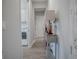 Hallway with console table, leading to laundry room at 3735 Conservation Trl, The Villages, FL 32163