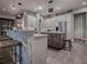 Modern kitchen with an island, stainless steel appliances, and white cabinets at 3735 Conservation Trl, The Villages, FL 32163