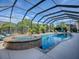 Enclosed pool and spa with a relaxing patio area at 3735 Conservation Trl, The Villages, FL 32163