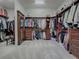 Large walk-in Primary closet with ample shelving and drawers at 3735 Conservation Trl, The Villages, FL 32163