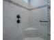 Modern shower with marble tile and built-in seat at 3735 Conservation Trl, The Villages, FL 32163