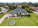 Aerial view of a single-Gathering home with a large yard and stone accents at 39248 Tacoma Dr, Lady Lake, FL 32159