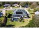 Aerial view showcasing a house, pool, and lush landscaping at 39248 Tacoma Dr, Lady Lake, FL 32159