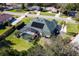 Aerial view of a house with solar panels, pool, and landscaped yard at 39248 Tacoma Dr, Lady Lake, FL 32159