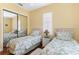 Bedroom with two twin beds and mirrored closet at 39248 Tacoma Dr, Lady Lake, FL 32159