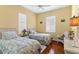 Charming bedroom with twin beds, wood floors, and window shutters at 39248 Tacoma Dr, Lady Lake, FL 32159