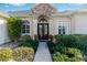 Inviting entryway with a stone accent wall and double doors at 39248 Tacoma Dr, Lady Lake, FL 32159