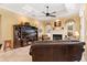 Relaxing living room with fireplace, built-in shelving, and leather couches at 39248 Tacoma Dr, Lady Lake, FL 32159