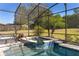 Large screened-in pool and spa with seating at 39248 Tacoma Dr, Lady Lake, FL 32159