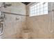 Large walk-in shower with tiled walls and built-in seat at 39248 Tacoma Dr, Lady Lake, FL 32159