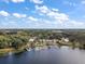 Wide aerial view of lakefront home and landscape at 39645 Turek Ln, Umatilla, FL 32784