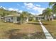 Large backyard with walkway and two buildings at 39645 Turek Ln, Umatilla, FL 32784