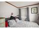 Main bedroom with gray bedding and window blinds at 39645 Turek Ln, Umatilla, FL 32784