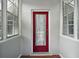 Red front door entrance with lace curtains at 39645 Turek Ln, Umatilla, FL 32784