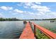 Wooden dock with bench overlooking the lake at 39645 Turek Ln, Umatilla, FL 32784