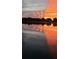 Dramatic sunset reflected on calm lake waters at 39645 Turek Ln, Umatilla, FL 32784