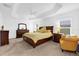 Main bedroom with wood furniture and ceiling fan at 4348 Tuscaloosa Path, The Villages, FL 32163