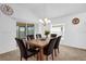 Bright dining room with six-chair table and view to kitchen at 4348 Tuscaloosa Path, The Villages, FL 32163