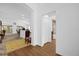 Hallway with wood floors, view of bathroom and living areas at 4348 Tuscaloosa Path, The Villages, FL 32163