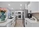 Modern kitchen with white cabinets and stainless steel appliances at 460 Brook Ridge Cir, Minneola, FL 34715