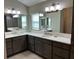 Double vanity bathroom with large mirror and plenty of storage at 5078 Lawler Loop, The Villages, FL 32163