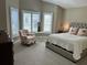 Spacious bedroom with a plush bed and window shutters at 5078 Lawler Loop, The Villages, FL 32163