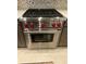 Stainless steel Wolf range with red knobs at 5078 Lawler Loop, The Villages, FL 32163