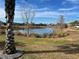 Scenic view of a lake with lush greenery and homes at 5078 Lawler Loop, The Villages, FL 32163