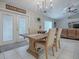 Casual dining area with farmhouse-style table and French doors at 51 Cr 532B, Bushnell, FL 33513