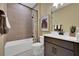 Well-lit bathroom showcasing a bathtub with tile surround and a vanity with ample counter space at 5221 Blanket Flower St, Apopka, FL 32712