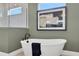 Relaxing bathroom features a standalone tub, modern art, and ample natural light at 5221 Blanket Flower St, Apopka, FL 32712