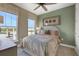 Bright bedroom with large windows, ceiling fan, and neutral decor at 5221 Blanket Flower St, Apopka, FL 32712