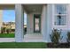 View of the front door and porch area of the house, featuring manicured landscaping at 5221 Blanket Flower St, Apopka, FL 32712