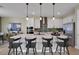 Modern kitchen with white cabinets, stainless steel appliances, and a quartz countertop island with pendant lights at 5221 Blanket Flower St, Apopka, FL 32712