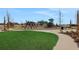 Scenic view of community playground, featuring green space, play equipment, and walking paths at 5221 Blanket Flower St, Apopka, FL 32712