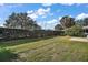 Landscaped backyard with wooden fence at 526 Kingston Way, The Villages, FL 32162