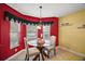 Bright breakfast nook features a glass-top table and two chairs at 526 Kingston Way, The Villages, FL 32162