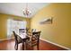 Formal dining room with hardwood floors and a view of the kitchen at 526 Kingston Way, The Villages, FL 32162