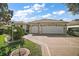 Two-car garage and well-maintained front yard at 526 Kingston Way, The Villages, FL 32162