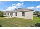 Single-story house with backyard patio and lawn at 526 Kingston Way, The Villages, FL 32162