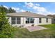 Single-story house with backyard patio and lawn at 526 Kingston Way, The Villages, FL 32162