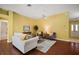 Living room with hardwood floors, neutral walls, and view into the kitchen and dining area at 526 Kingston Way, The Villages, FL 32162