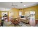 Living room with hardwood floors, comfortable seating, and views into dining and kitchen areas at 526 Kingston Way, The Villages, FL 32162