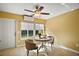 Relaxing sunroom with ample natural light and a ceiling fan at 526 Kingston Way, The Villages, FL 32162