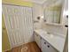 Bathroom featuring a vanity, mirrored cabinet, and large closet for storage at 534 Palo Verde Dr, Leesburg, FL 34748