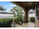 Inviting front porch with lush greenery and wrought-iron railing at 548 Cascade Cir # 100, Casselberry, FL 32707