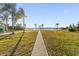 Landscaped backyard with a path leading to the water at 5526 Parkdale Dr, Orlando, FL 32839