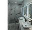 Modern bathroom with double sinks, a large shower, and marble tile at 5526 Parkdale Dr, Orlando, FL 32839