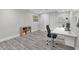 Home office with white desk, black chair, and built-in shelving at 5526 Parkdale Dr, Orlando, FL 32839