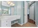 Bathroom with a vanity and access to the main bedroom and other rooms at 6026 Landings Blvd, Lady Lake, FL 32159